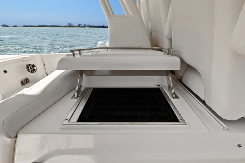 Slide: The Image of 2023 Grady-White Canyon 456 boat interior with open storage compartment, ocean view. - 39