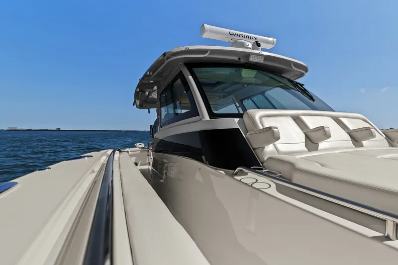 Slide: The Image of 2023 Grady-White Canyon 456 boat on open water, showcasing luxury seating and sleek design. - 67