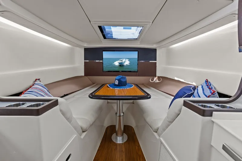Slide: The Image of Luxurious interior of 2023 Grady-White Canyon 456 boat with seating, table, and TV. - 49