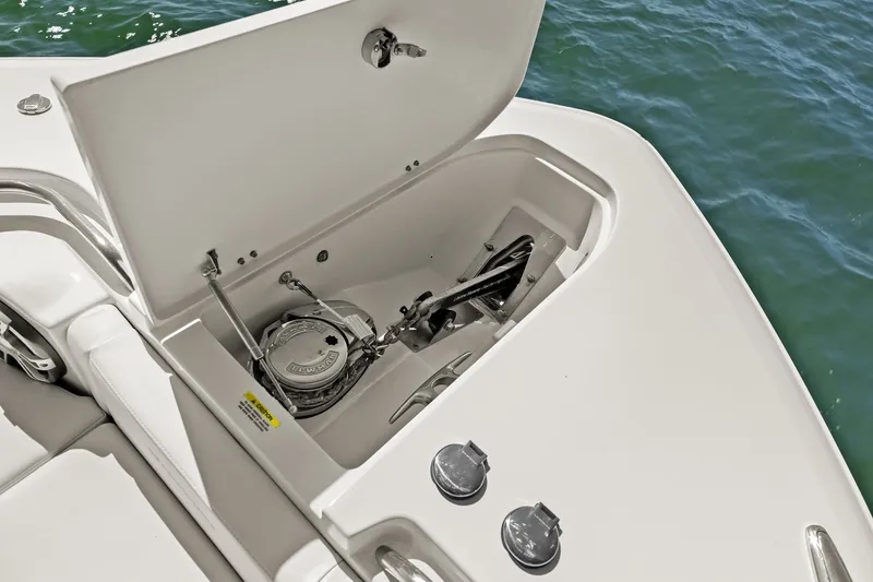 Slide: The Image of Anchor compartment of 2023 Grady-White Canyon 456 boat, open on calm water. - 64
