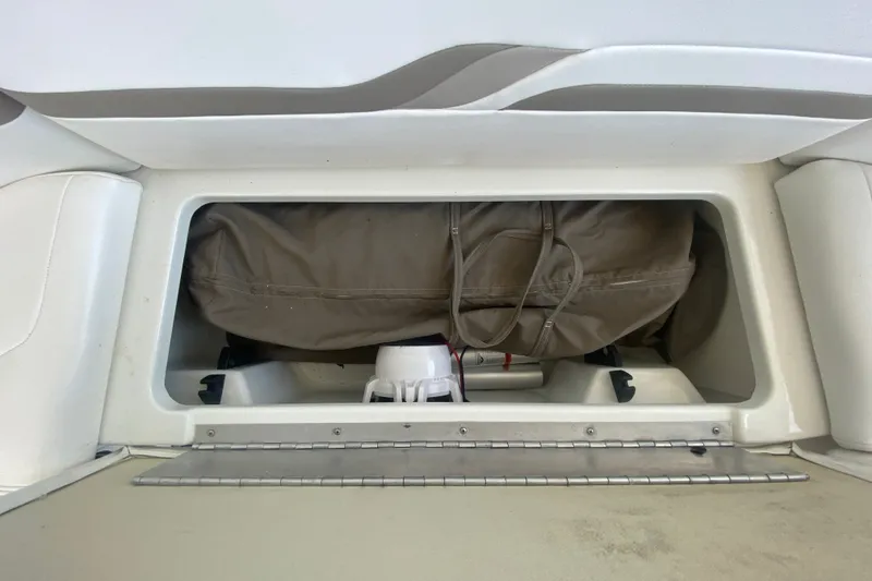 Slide: The Image of Storage compartment in a 2000 Formula 400 Super Sport boat, containing a bag and equipment. - 16