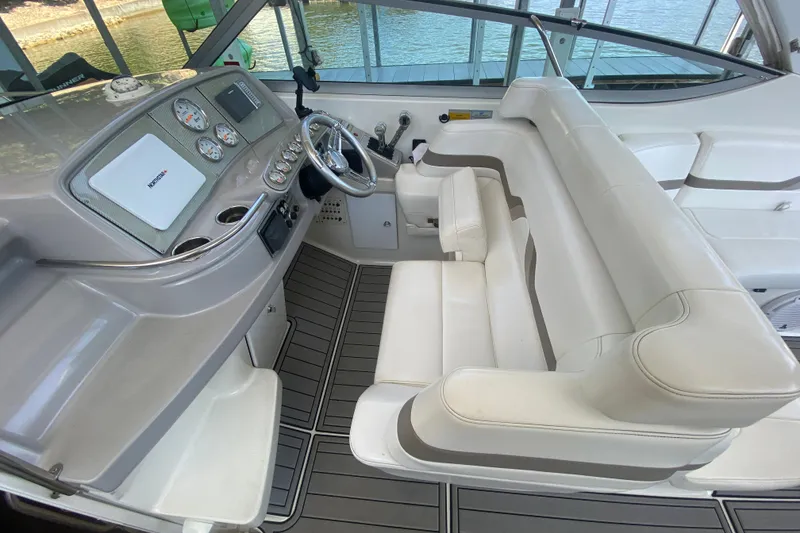 Slide: The Image of Interior of a 2000 Formula 400 Super Sport boat with white seating and control panel. - 17
