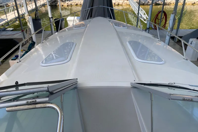 Slide: The Image of Bow view of a 2000 Formula 400 Super Sport boat docked at a marina. - 28