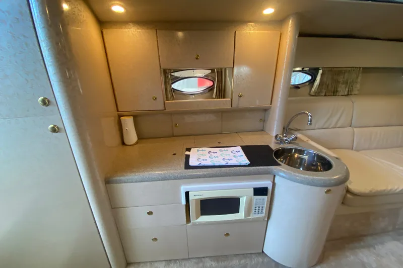 Slide: The Image of Interior of 2000 Formula 400 Super Sport yacht with kitchenette and seating area. - 42