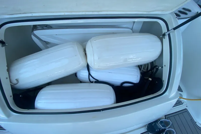 Slide: The Image of Storage compartment with white boat fenders on a 2000 Formula 400 Super Sport. - 55