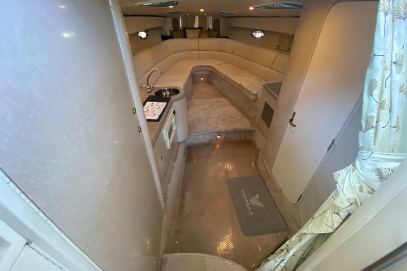 Slide: The Image of Interior of 2000 Formula 400 Super Sport boat with beige seating and compact kitchenette. - 29