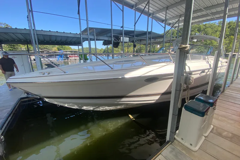 The Image of 2000 Formula 400 Super Sport boat docked in a covered marina. - 1