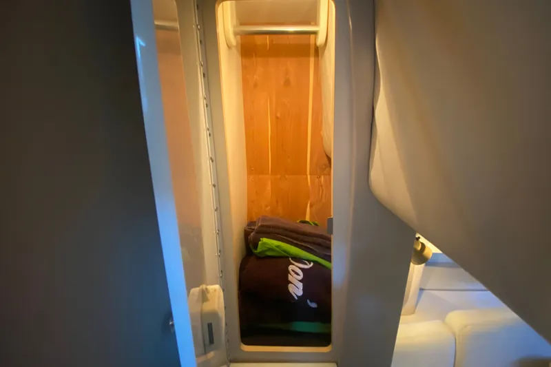 Slide: The Image of Interior storage space in a 2000 Formula 400 Super Sport boat, featuring wooden paneling. - 38