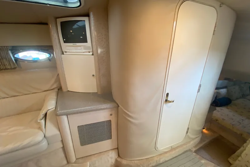 Slide: The Image of Interior of 2000 Formula 400 Super Sport yacht with TV, seating, and cabin door. - 32