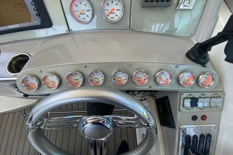 Slide: The Image of Dashboard of a 2000 Formula 400 Super Sport boat with gauges and steering wheel. - 19
