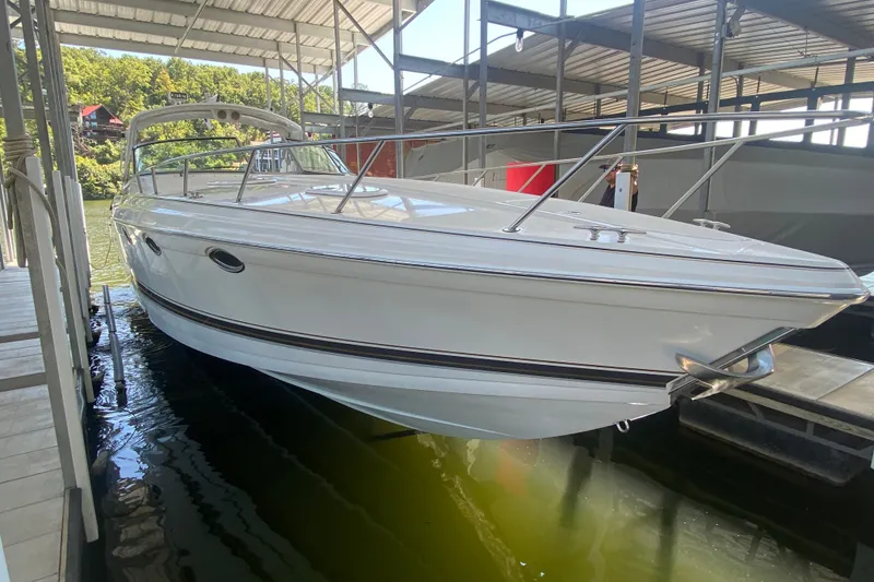 Slide: The Image of 2000 Formula 400 Super Sport boat docked in a covered marina. - 2