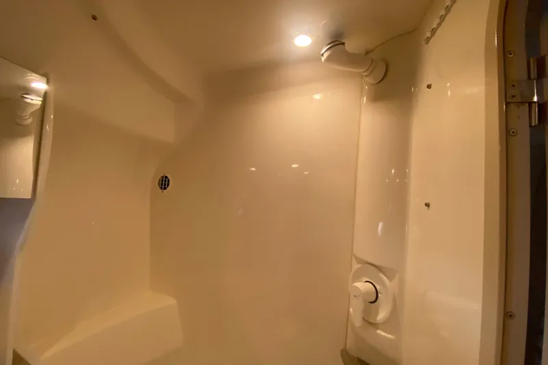 Slide: The Image of Interior of a 2000 Formula 400 Super Sport boat, featuring a sleek, modern shower area. - 36