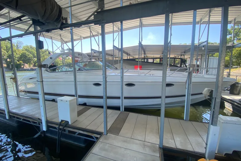 Slide: The Image of 2000 Formula 400 Super Sport boat docked in a covered marina. - 4