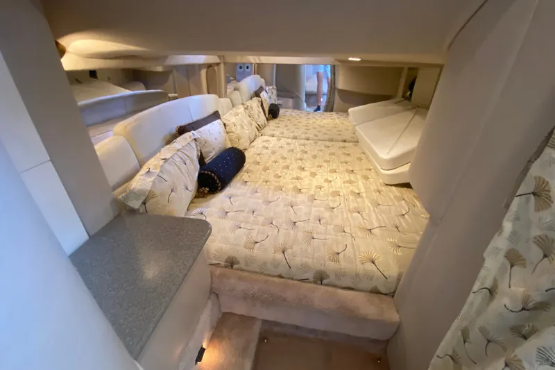 Slide: The Image of Interior cabin of a 2000 Formula 400 Super Sport boat, featuring a cozy bed setup. - 45