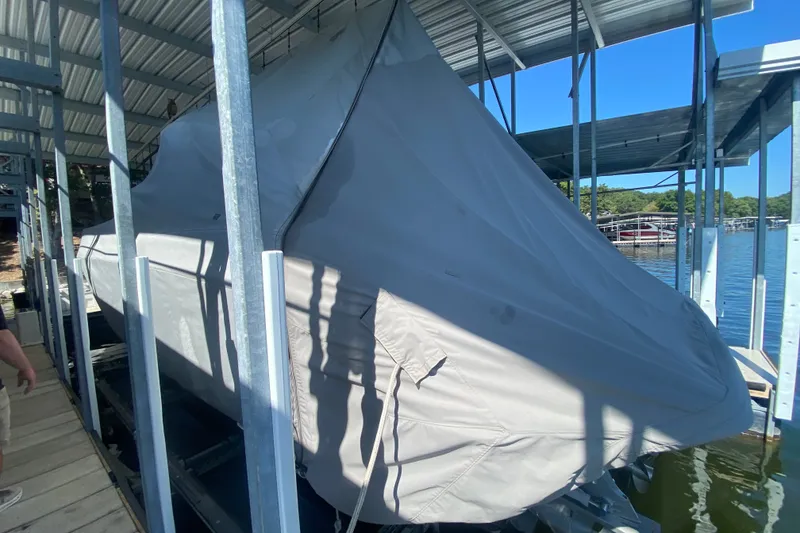 Slide: The Image of Covered 2000 Formula 400 Super Sport boat docked under a metal canopy. - 57