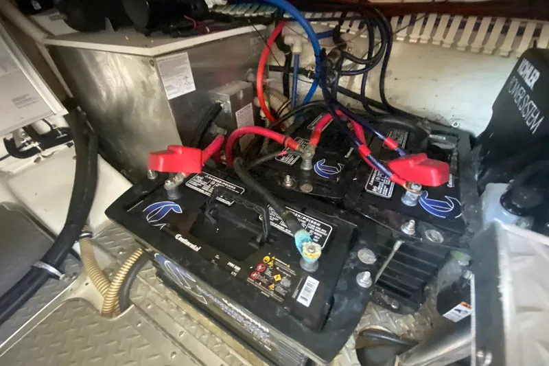 Slide: The Image of Battery compartment of a 2000 Formula 400 Super Sport boat, featuring multiple connected batteries. - 52