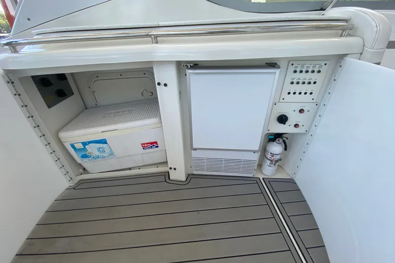 Slide: The Image of Interior of a 2000 Formula 400 Super Sport boat with cooler and control panel. - 13