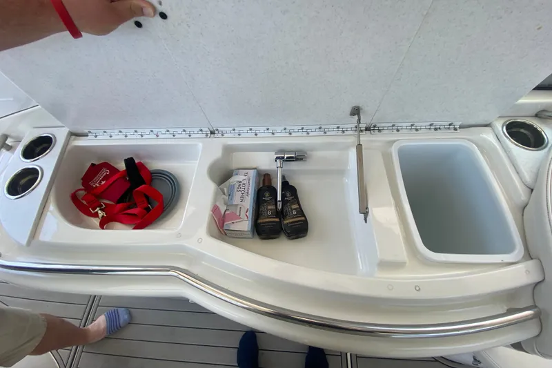 Slide: The Image of Storage compartment on a 2000 Formula 400 Super Sport boat with various items. - 12