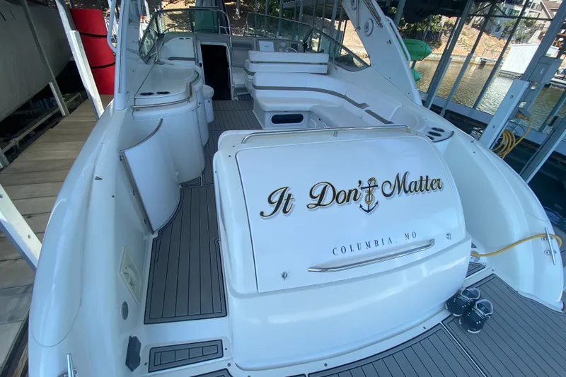 Slide: The Image of 2000 Formula 400 Super Sport boat docked, featuring spacious seating and sleek design. - 7