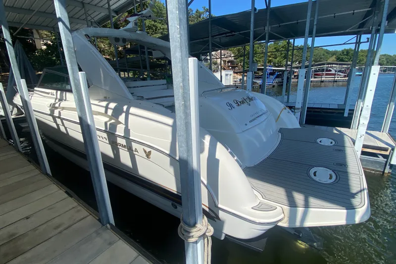 Slide: The Image of 2000 Formula 400 Super Sport boat docked in a marina under a covered slip. - 53