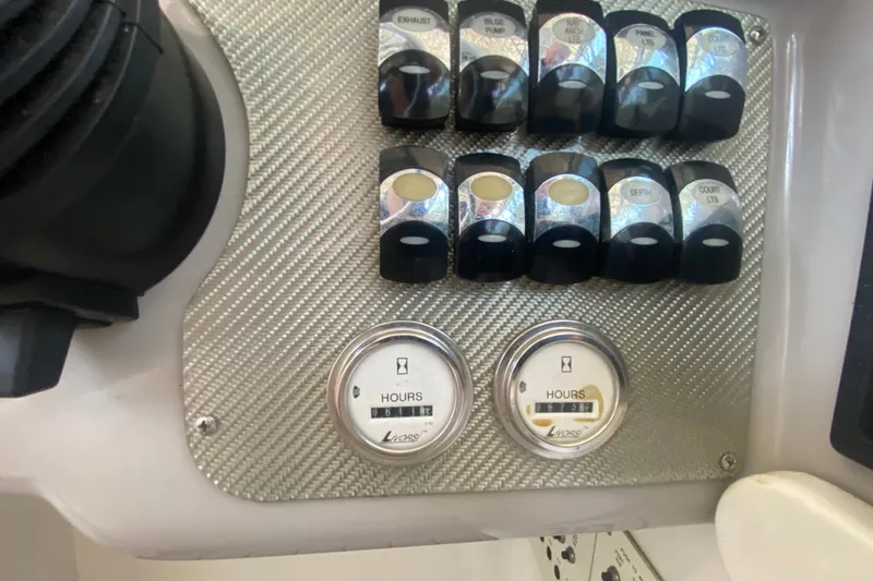 Slide: The Image of Control panel of a 2000 Formula 400 Super Sport boat with switches and hour meters. - 25