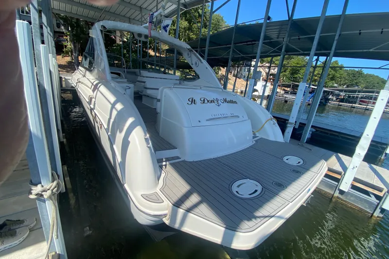 Slide: The Image of 2000 Formula 400 Super Sport boat docked in a marina, rear view. - 54