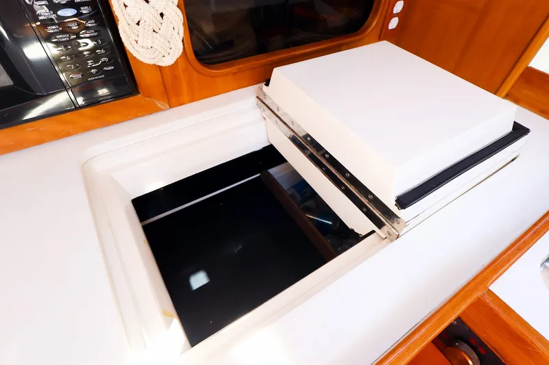 Slide: The Image of Interior of 2002 J Boats J/120 yacht showing a built-in storage compartment. - 46