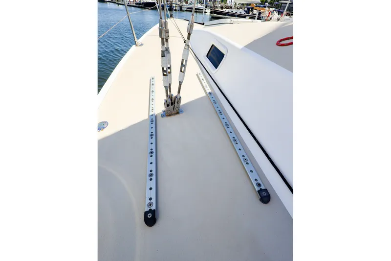 Slide: The Image of Deck view of a 2002 J Boats J/120 sailboat, featuring rigging and tracks. - 22