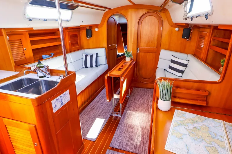 Slide: The Image of Interior of 2002 J Boats J/120 sailboat with wood finish and cozy seating area. - 34