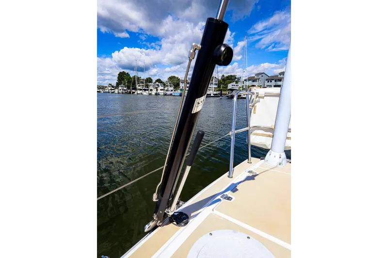 Slide: The Image of 2002 J Boats J/120 sailboat deck with marina view under blue sky. - 28