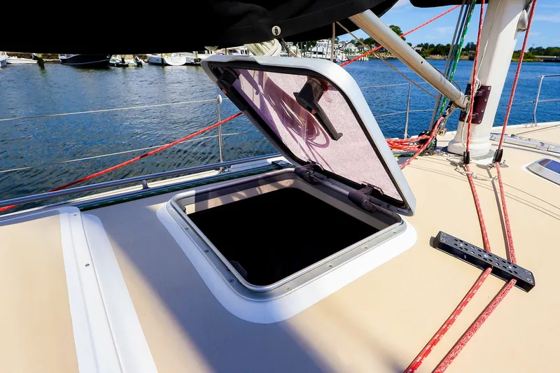 Slide: The Image of Open hatch on 2002 J Boats J/120 sailboat deck, with ropes and water view. - 26