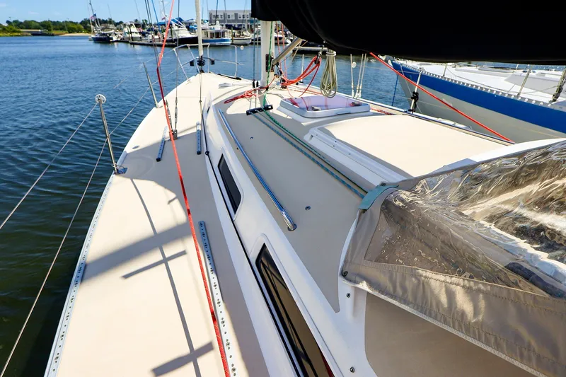 Slide: The Image of 2002 J Boats J/120 sailboat deck with rigging, docked at marina. - 9