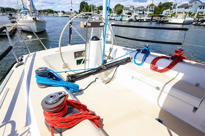 Slide: The Image of Cockpit of 2002 J Boats J/120 sailboat with colorful ropes and marina view. - 14