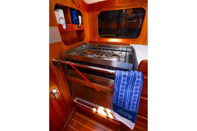 Slide: The Image of Galley of 2002 J Boats J/120 with stove, oven, and blue towel. - 43