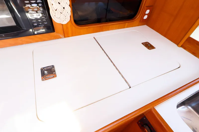 Slide: The Image of Galley countertop with storage on a 2002 J Boats J/120 sailboat. - 45