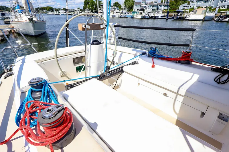 Slide: The Image of Cockpit of 2002 J Boats J/120 sailboat with ropes and steering wheel in marina. - 13