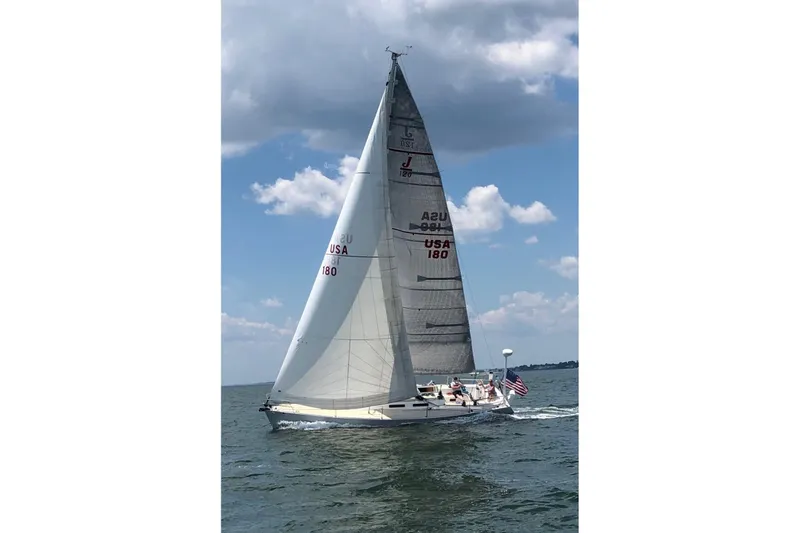 Slide: The Image of 2002 J Boats J/120 sailing on open water under a partly cloudy sky. - 1