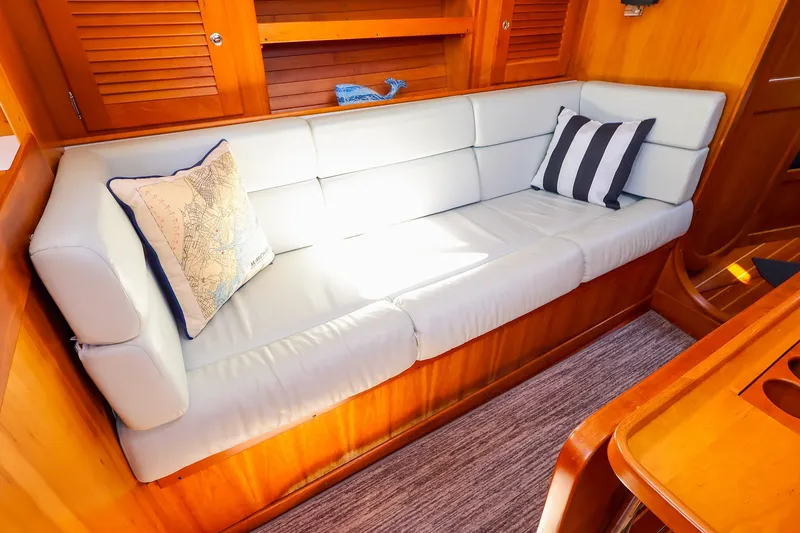 Slide: The Image of Luxurious interior of 2002 J Boats J/120 with comfortable seating and nautical-themed pillows. - 48