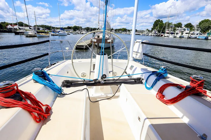 Slide: The Image of Cockpit view of 2002 J Boats J/120 sailboat docked in a marina under blue skies. - 11