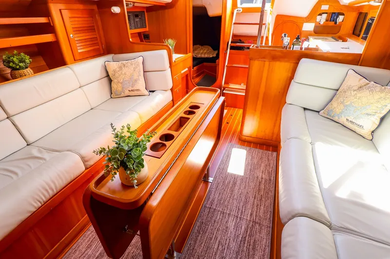 Slide: The Image of Luxurious interior of 2002 J Boats J/120 yacht with elegant wood finish and plush seating. - 51