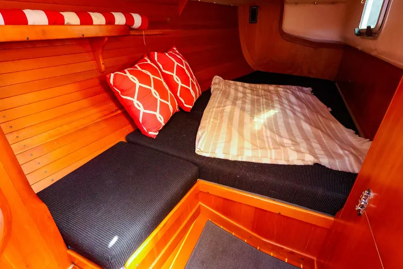 Slide: The Image of Cozy cabin interior of 2002 J Boats J/120 with cushions and pillows. - 54