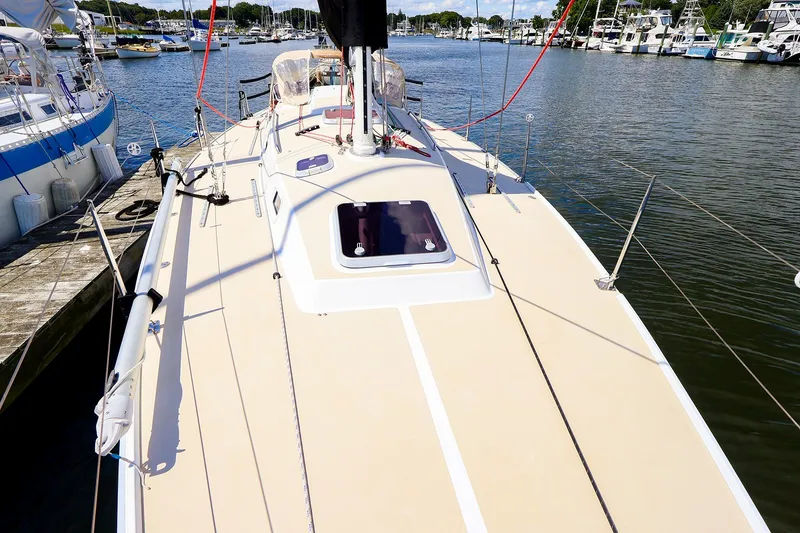Slide: The Image of 2002 J Boats J/120 sailboat docked in a marina, showcasing deck and rigging. - 8