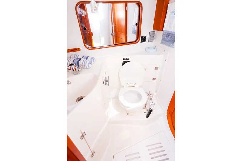 Slide: The Image of Bathroom interior of 2002 J Boats J/120 yacht, featuring a toilet and sink. - 53