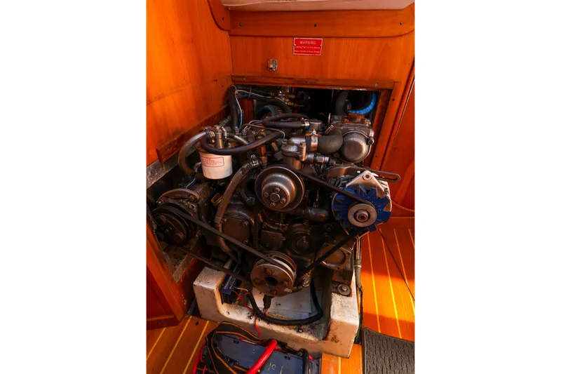 Slide: The Image of Engine compartment of a 2002 J Boats J/120 sailboat, showcasing mechanical components. - 56