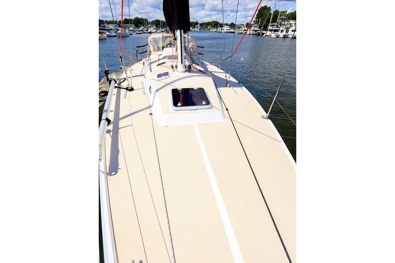 Slide: The Image of 2002 J Boats J/120 sailboat deck view, docked in a marina under a clear sky. - 24