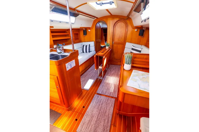 Slide: The Image of Luxurious interior of 2002 J Boats J/120 sailboat with wood finish and cozy seating. - 35