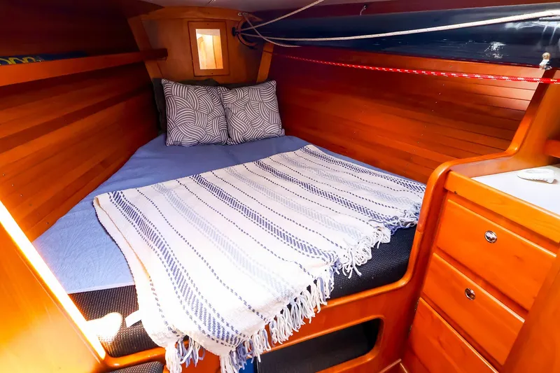 Slide: The Image of Cozy cabin interior of 2002 J Boats J/120 with wooden finish and comfortable bedding. - 52