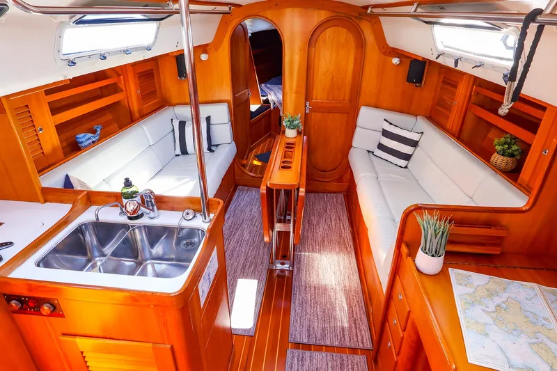 Slide: The Image of Luxurious interior of 2002 J Boats J/120 sailboat with wood finish and cozy seating. - 36