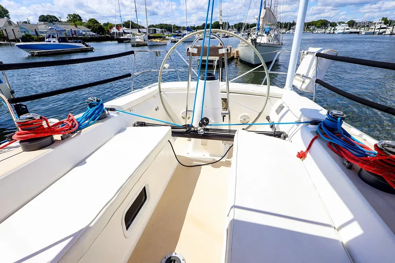 Slide: The Image of Cockpit of 2002 J Boats J/120 sailboat with ropes and steering wheel in marina. - 18