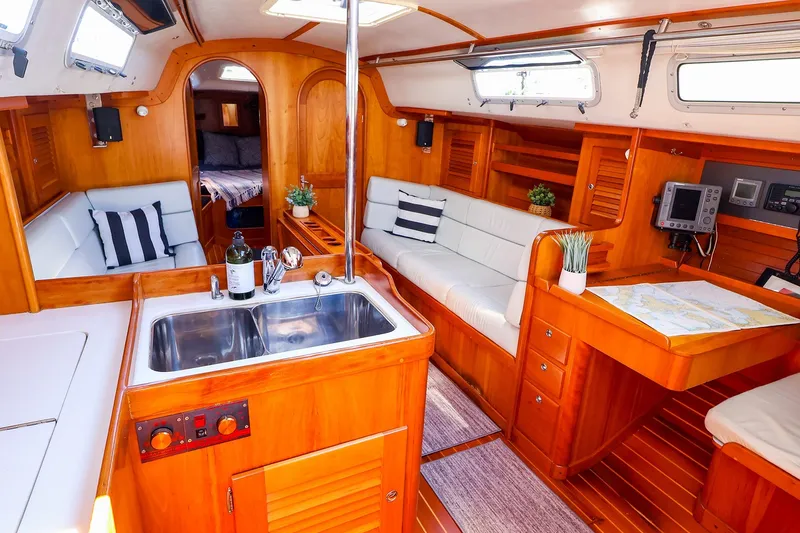 Slide: The Image of Luxurious 2002 J Boats J/120 yacht interior with wood finish, cozy seating, and navigation area. - 37